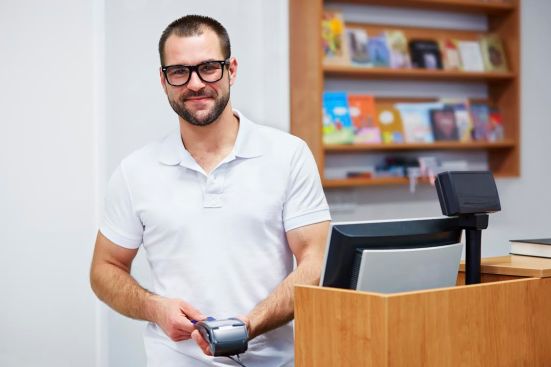 Salesman at the checkout in a bookstore