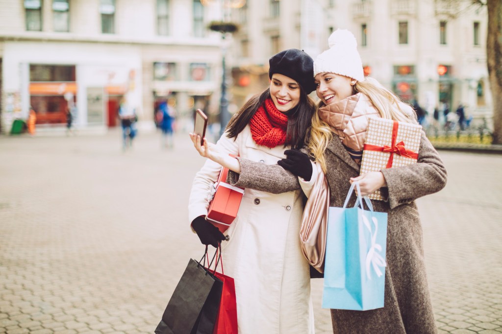Friends are taking a selfies with Christmas presents